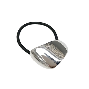 Elastic hair tie with a polished silver geometric metal charm for a minimalist modern look