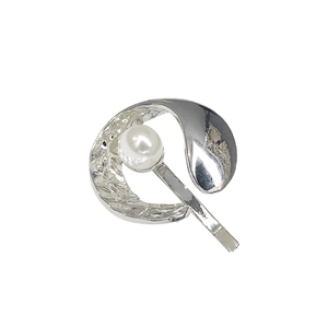 Minimalist silver metal ponytail hook with pearl accent and hammered texture detail