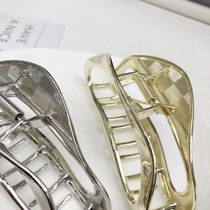 Polished gold and silver metal shark hair clips with non-slip checkered inner texture