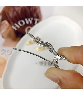 Close-up of a silver wave hair clip showing durable metal teeth for secure grip