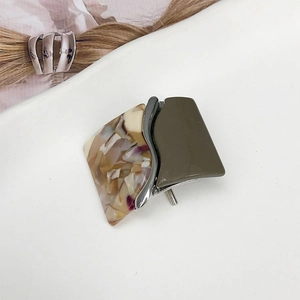 Detail view of square leopard resin hair hook with marble texture and silver metal separator