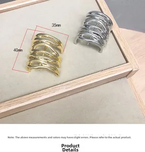 Detail view of layered wave design metal hair pins in gold and silver finish 40mm