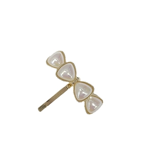 Elegant gold hair hook with white pearl-like triangles for stylish women hairstyles