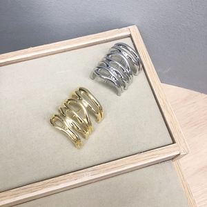 Minimalist wavy metal hair hooks in gold and silver finish on a jewelry tray