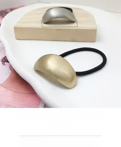 Detail view of 42mm brushed metal semicircular ornament on minimalist hair scrunchies