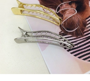 Detail of wavy metal hair clips in gold and silver finish with anti-slip inner teeth