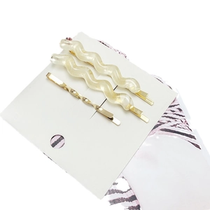 Three-piece hair clip set with cream wavy resin pins and golden metal twist barrette