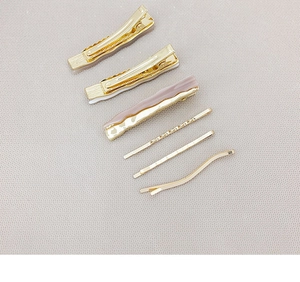 Detailed close-up of 6-piece hair clip set including gold bobby pins and acrylic duckbill clips