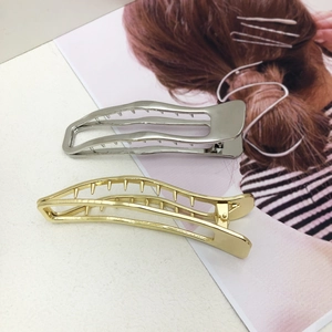 Vintage metal swallowtail hair clips in gold and silver with wavy hollow design