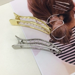 Set of gold and silver vintage hollow metal hair clips with polished finish and teeth