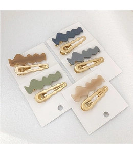 Five sets of wavy hair clips featuring matte colors and gold metal on display cards
