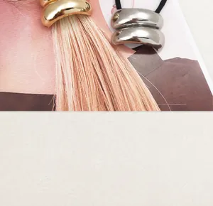 Detail of minimalist gold and silver metal ponytail holders with high-elasticity hair ties