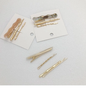 Detail of golden hair clip set with amber and gray marble acetate patterns