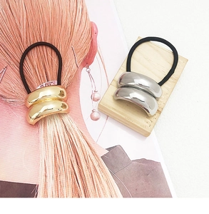 Detailed view of metal U-shaped hair ties in gold and silver finish with elastic band