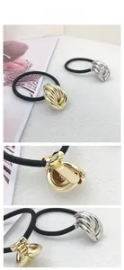 Macro detail of high-elastic black hair ties with golden and silver twisted alloy knots