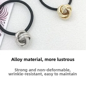 Close-up of gold and silver alloy metal circle hair ties with black elastic bands