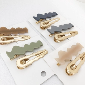 Morandi color wave hair clips set with gold hollow design on clean white background