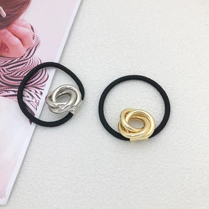 Minimalist gold and silver intertwined metal hair rings set on white background