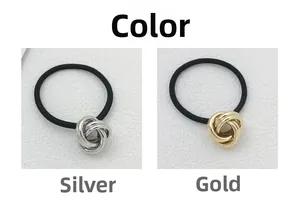 Detailed close-up of metallic twisted knot charms in silver and gold on elastic hair ties