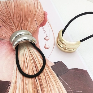 Minimalist metallic U-shaped hair tie in gold and silver finish for sleek ponytails