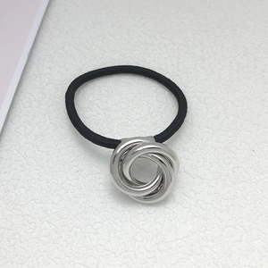 Detail shot of black elastic hair tie with three interlocking silver metal rings design