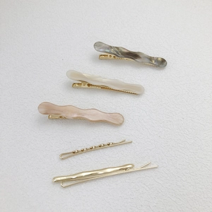 5-piece hair clip set with marble acetate duckbill clips and gold wave hairpins