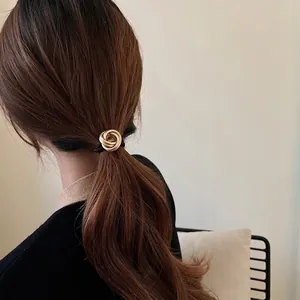 Minimalist gold knot hair tie for women with elegant metallic ring design for ponytails