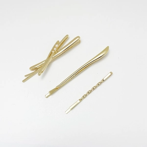 Three-piece gold alloy hair clip set with minimalist pearl cross and textured duckbill pins