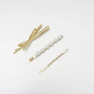 Three-piece gold alloy hair clip set with elegant pearls and minimalist twisted wave design