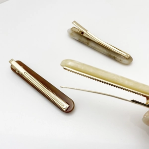 Three-piece resin hair clip set in coffee brown, marble beige, and cream yellow