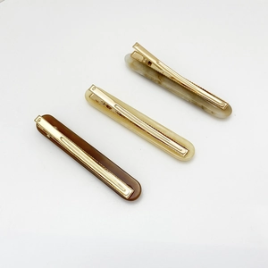 Detailed top view of three resin barrette hair clips in coffee and marble textures