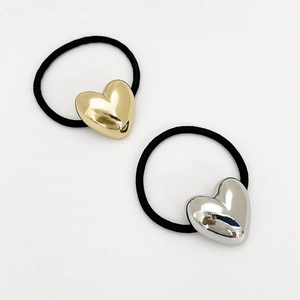 Detail of high-elasticity hair ties with gold and silver metallic heart charms