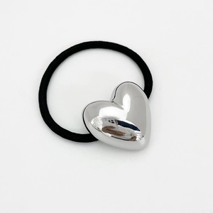 Detailed close-up of a high-elastic black hair tie featuring a polished silver heart charm