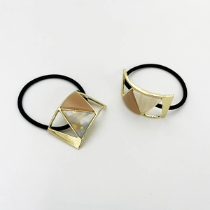 Set of two minimalist U-shaped geometric hair ties with resin marble patterns in gold alloy