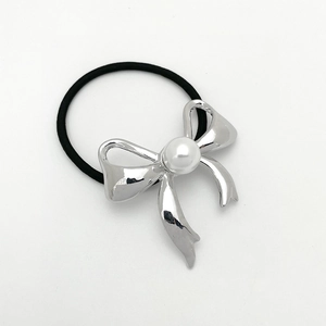 Detail of high-elasticity hair tie featuring a silver bowknot and white faux pearl