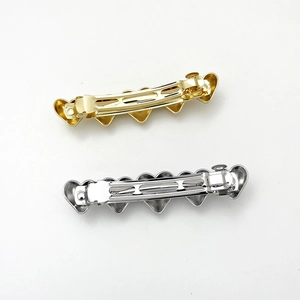 Minimalist gold and silver metal heart-shaped hair clips with spring clamp design