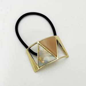 Detail of high-elastic hair tie with U-shaped alloy geometric frame and resin resin marble inlay