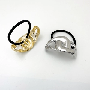 Polished alloy metal knot ponytail holder set in gold and silver finish on black elastic band