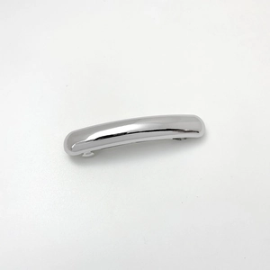 Polished silver metal spring hair clip detail with minimalist curved design and high gloss finish
