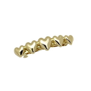 Elegant gold heart hair clip with polished metallic finish for women's hair styling