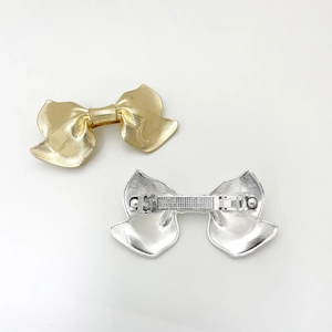 Elegant gold and silver bow hair clips with textured metal stripes for women