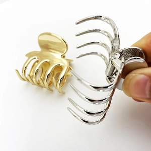 Detail of metal hair claw clips with strong spring and polished gold and silver finish