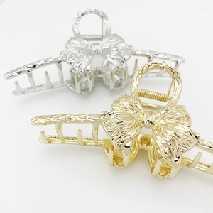 Large metal bow hair claw clips in gold and silver finish for thick hair styling