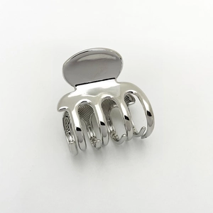 Close-up of a square silver metal hair claw clip with a polished finish and multi-tooth design