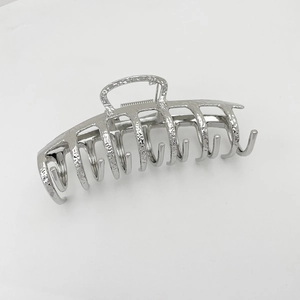 Detailed close-up of large silver alloy hair claw clip with hammered metal texture finish
