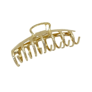 Minimalist golden metal hair claw clip with hammered texture finish for women styling