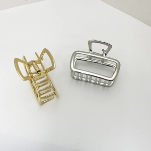 Detail of square hollow metal hair claws in glossy gold and silver finish sets