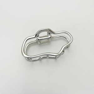 Close-up of silver wavy metal hair claw with geometric minimalist hollow design