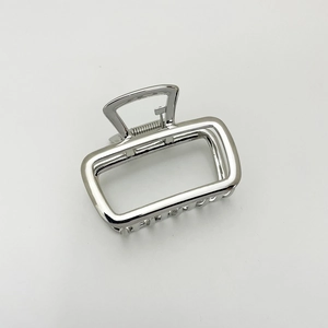 Macro shot of polished silver rectangle hollow metal hair claw clip with strong metal spring