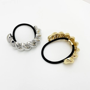 Minimalist elastic hair ties featuring textured gold and silver twisted metal accents